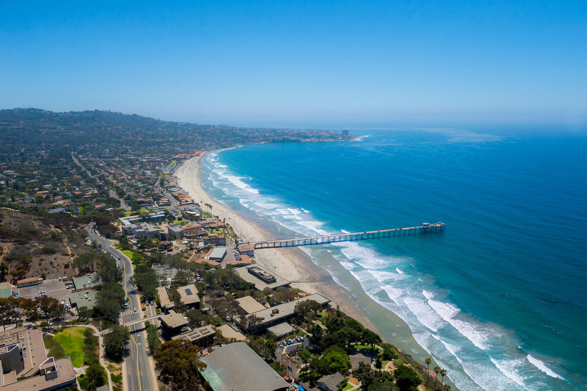 Aerial view of UC San Diego's Scripps pier and the Pacific Ocean coast line. 